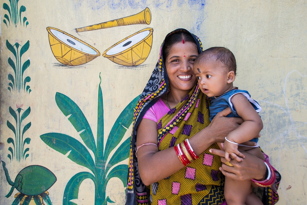 Indian woman holding her child